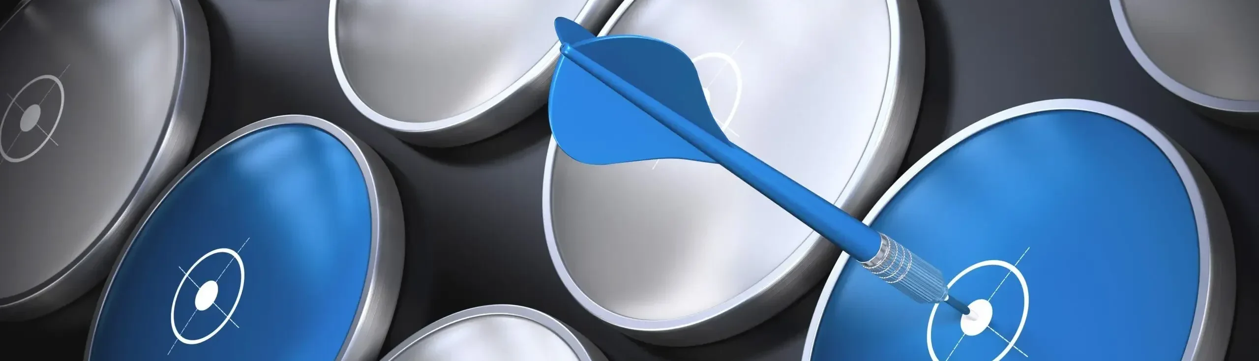 A close-up of a grid of glossy blue and silver dartboard-like discs on a dark background, with a single blue dart striking the bullseye of one blue disc.